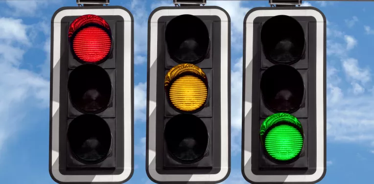 Traffic lights showing red, amber and green